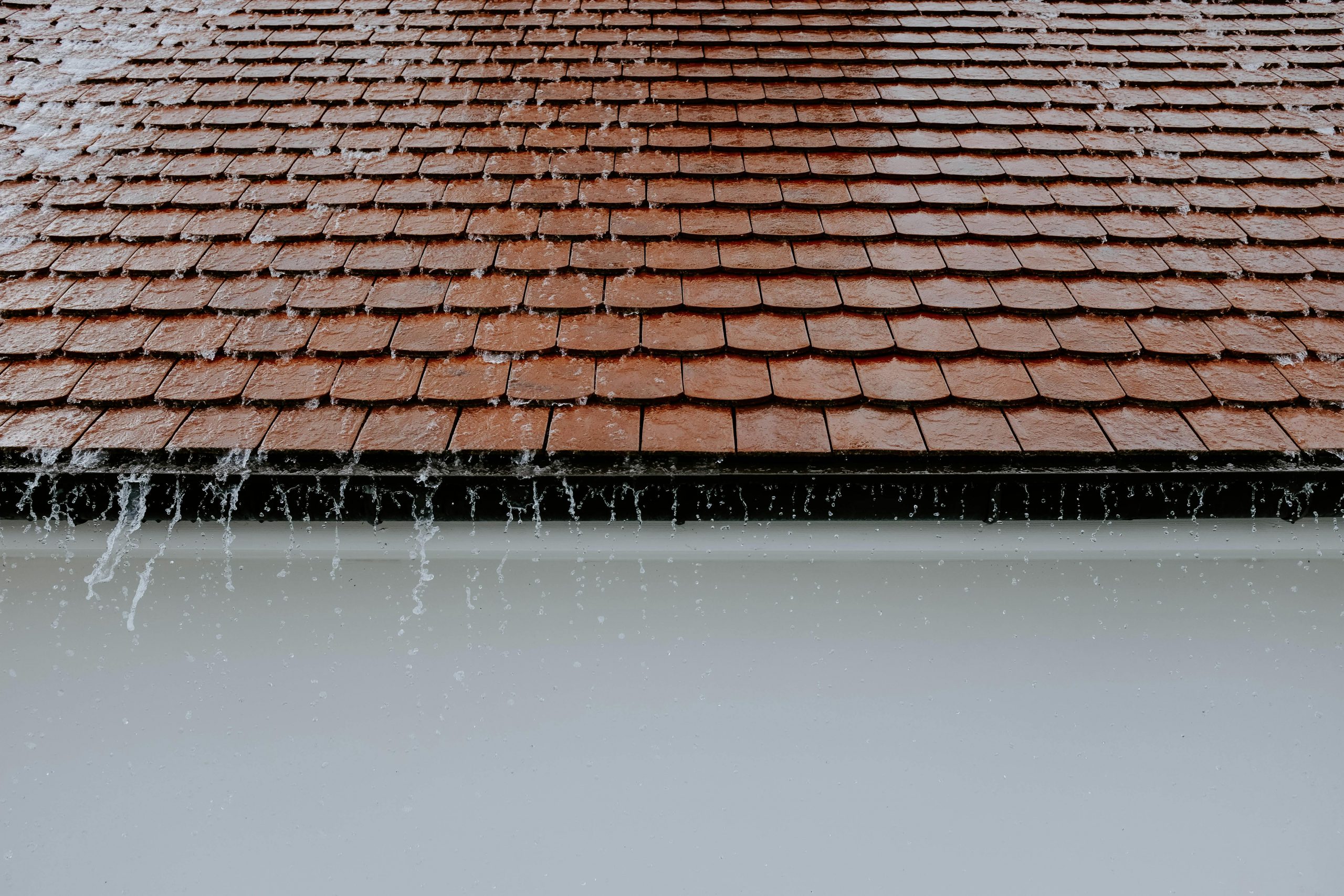 Water flowing from a roof through a collection pipe